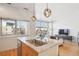 Bright kitchen featuring granite countertops, stainless steel sink, and modern pendant lighting at 2958 Syracuse St # 316, Denver, CO 80238