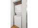 Compact laundry closet features a stacked washer and dryer set, perfect for maximizing space at 2958 Syracuse St # 316, Denver, CO 80238