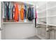 Well-organized walk-in closet with shelving, hanging rods and pull out wire baskets offer ample storage space at 2958 Syracuse St # 316, Denver, CO 80238
