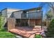 Multi-tiered deck in fenced backyard, with mature trees and landscaping, and gray siding at 6969 W Yale Ave # 81, Denver, CO 80227