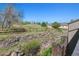 Backyard view with wooden fence, green grass, and a neighboring house at 6969 W Yale Ave # 81, Denver, CO 80227