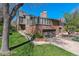 Charming two-story home with brick and gray siding, attached garage and mature trees at 6969 W Yale Ave # 81, Denver, CO 80227