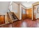 Inviting foyer with hardwood floors, staircase, and decorative glass front door at 6969 W Yale Ave # 81, Denver, CO 80227