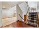 Entryway with a wooden staircase featuring a patterned carpet runner and hardwood flooring at 6969 W Yale Ave # 81, Denver, CO 80227