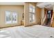 Bright living room featuring tall windows, wet bar, and staircase to the second floor at 6969 W Yale Ave # 81, Denver, CO 80227