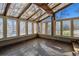 Bright sun room featuring a glass ceiling, multiple windows, and brick flooring at 6969 W Yale Ave # 81, Denver, CO 80227