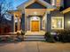 Inviting home entryway with a charming portico, wooden double doors, and professionally landscaped surroundings at 4825 6Th St, Boulder, CO 80304