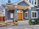 Stunning close up shot of the home's front entrance featuring a beautiful natural wood double door at 4825 6Th St, Boulder, CO 80304