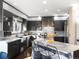 Modern kitchen featuring glossy cabinetry, stainless steel appliances, and a chic island with barstool seating at 4825 6Th St, Boulder, CO 80304