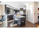 Contemporary kitchen offers sleek cabinetry, marble countertops, and an island with stylish barstools for casual dining at 4825 6Th St, Boulder, CO 80304