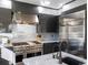 High-end kitchen includes a professional-grade stovetop, sleek cabinetry, and a spacious refrigerator for culinary enthusiasts at 4825 6Th St, Boulder, CO 80304