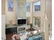 Bright living room with a fireplace, high ceilings, large windows, and views of the mountains at 4825 6Th St, Boulder, CO 80304