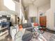 Bright living room boasts soaring ceilings, hardwood floors, and elegant staircase with comfortable, stylish furnishings at 4825 6Th St, Boulder, CO 80304