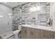 Modern bathroom featuring horizontal grey tile, frameless glass shower and a vanity with lighting at 1215 N Perry St, Denver, CO 80204