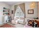 Bright ' bedroom with modern furnishings, large windows, and a cozy armchair near the bed at 1215 N Perry St, Denver, CO 80204