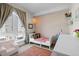 Bedroom with a twin bed, woven pendant light, large windows, and patterned wallpaper at 1215 N Perry St, Denver, CO 80204