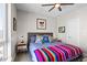 Bright bedroom with large windows, stylish bed with decorative pillows and contemporary art at 1215 N Perry St, Denver, CO 80204