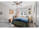 Bright bedroom with a decorative ceiling fan, world map, and crib, filled with natural light at 1215 N Perry St, Denver, CO 80204