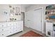 ' bedroom featuring a dresser, modern decor, sliding closet doors, shelving, and a playful toy refrigerator at 1215 N Perry St, Denver, CO 80204