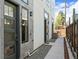 Modern townhome exterior featuring gray stone accents, modern lighting, and landscaped walkway at 1215 N Perry St, Denver, CO 80204