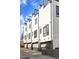 Modern townhome exterior featuring sleek architecture, balconies, and attached garages at 1215 N Perry St, Denver, CO 80204