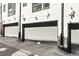 Exterior view of attached garages with contemporary doors and clean architectural lines at 1215 N Perry St, Denver, CO 80204
