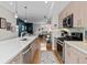 Open concept kitchen with a breakfast bar island, stainless appliances, and access to the living room at 1215 N Perry St, Denver, CO 80204