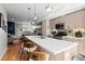 Open-concept kitchen with a large island, pendant lighting, breakfast bar, and stainless steel appliances at 1215 N Perry St, Denver, CO 80204