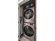 Modern laundry room with stacked washer and dryer for convenient in-home laundry at 1215 N Perry St, Denver, CO 80204