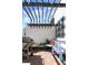 Outdoor patio with wooden pergola, grill, and furniture for relaxing or entertaining under a bright sky at 1215 N Perry St, Denver, CO 80204