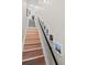 Staircase with light wood steps, gray carpet on the upper level and decorative photos along the wall at 1215 N Perry St, Denver, CO 80204