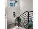 Modern staircase featuring a sleek metal railing and stylish decorative greenery at 1215 N Perry St, Denver, CO 80204