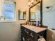 Bathroom features a vanity with storage and a decorative framed mirror at 234 Cypress Cir, Broomfield, CO 80020