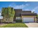Charming two-story home with a well-manicured lawn and a two-car garage on a sunny day at 234 Cypress Cir, Broomfield, CO 80020