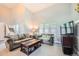 Bright living room with neutral colors, a large window, and comfortable seating, and a staircase in background at 234 Cypress Cir, Broomfield, CO 80020