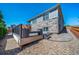 Back deck with stone details, wooden railing, and stone pathway, creating a serene outdoor oasis at 17028 Osage St, Broomfield, CO 80023