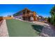 View of the AstroTurf yard with a deck that has a stone accent wall, and stairs to the backyard at 17028 Osage St, Broomfield, CO 80023