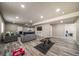Spacious finished basement featuring wood-look floors, a seating area, media center, and a dedicated workout space at 17028 Osage St, Broomfield, CO 80023