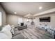 View of a finished basement with recessed lighting, wood-look floors, media center, and comfortable seating arrangement at 17028 Osage St, Broomfield, CO 80023