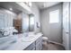 Bathroom featuring single sink and walk-in shower at 17028 Osage St, Broomfield, CO 80023