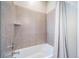Bathtub with tile surround and shower head at 17028 Osage St, Broomfield, CO 80023