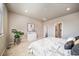 Bright bedroom featuring neutral tones, carpet floors, and a large window at 17028 Osage St, Broomfield, CO 80023