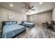 Bright bedroom with two beds, ceiling fan, and a workspace, offering a comfortable and versatile living area at 17028 Osage St, Broomfield, CO 80023