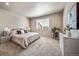 Serene main bedroom with a large window, plush carpet, and neutral decor at 17028 Osage St, Broomfield, CO 80023