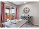 Elegant dining area features a modern table, stylish cabinet, and sliding glass doors to the outdoor deck at 17028 Osage St, Broomfield, CO 80023