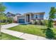 Inviting home exterior showcasing a well-kept lawn, stone accents, and a convenient two-car garage at 17028 Osage St, Broomfield, CO 80023