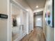 Bright hallway with wood flooring, leading to rooms with glass doors for open, modern living at 17028 Osage St, Broomfield, CO 80023