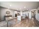 Spacious kitchen featuring modern white cabinets, an island, stainless steel appliances, and hardwood floors at 17028 Osage St, Broomfield, CO 80023