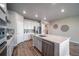 Stylish kitchen featuring a large island, stainless steel dishwasher, and modern fixtures at 17028 Osage St, Broomfield, CO 80023