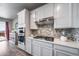 Modern kitchen featuring stainless steel appliances, stylish backsplash, and ample counter space at 17028 Osage St, Broomfield, CO 80023